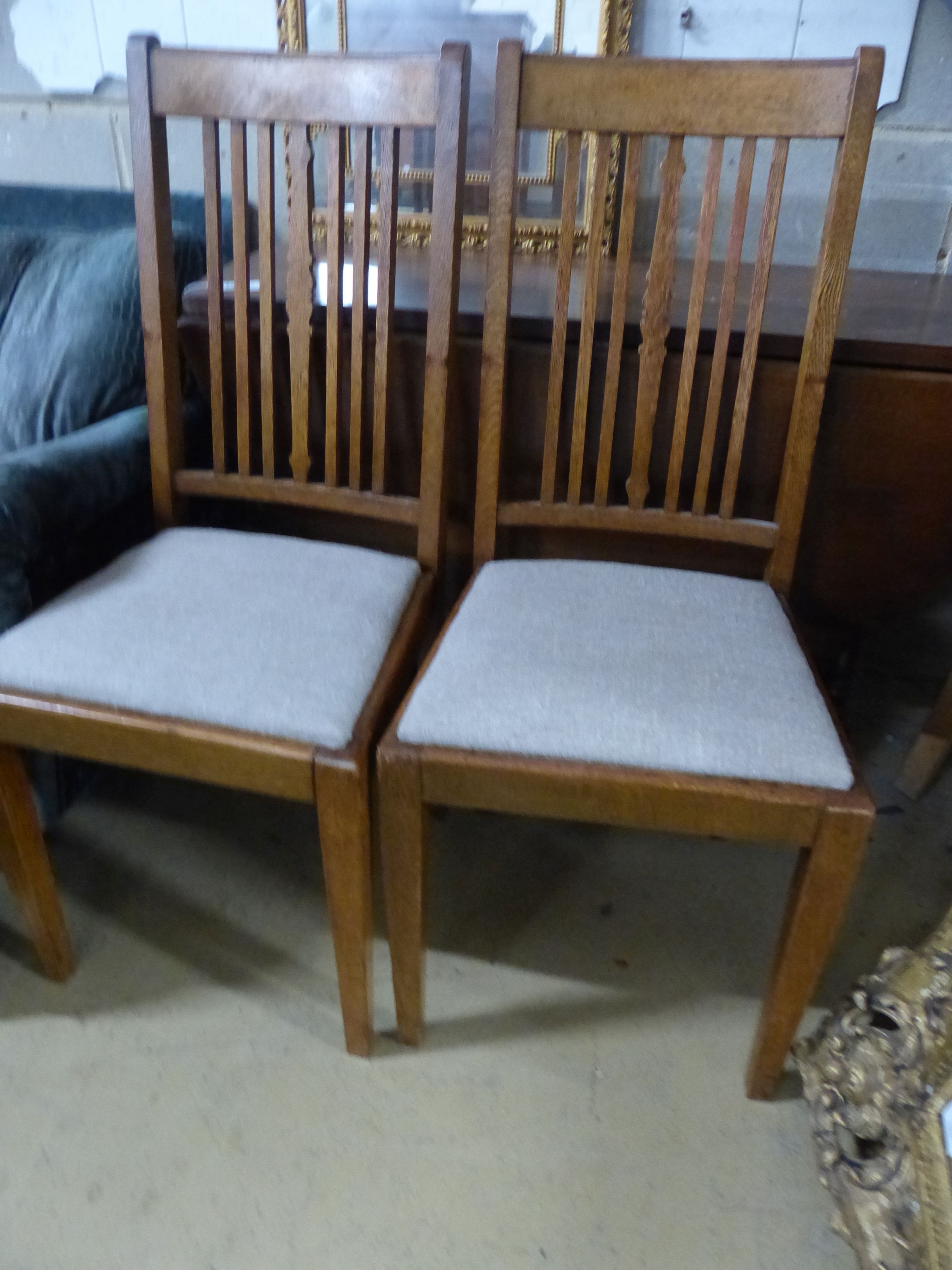 A set of four Edwardian oak dining chairs